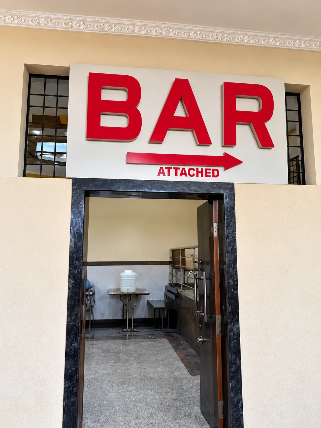 Bar Entrance with Attached Arrow Sign